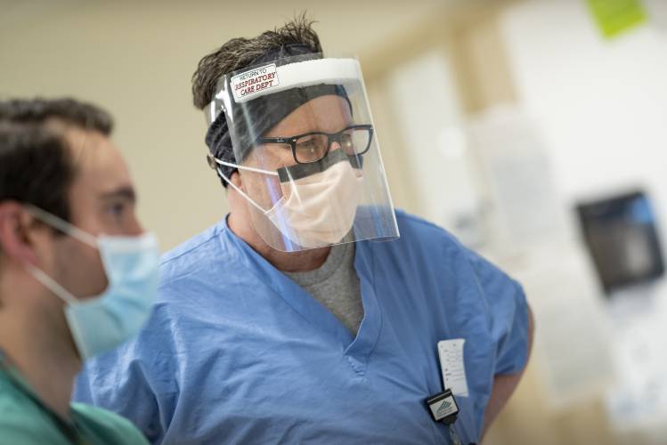 In this image provided Dartmouth-Hitchcock Health, Respiratory Care Practitioner Craig Skirvin, wears a face shield, Friday, May 1, 2020, at Dartmouth-Hitchcock Medical Center;s Medical Intensive Care Unit, where it cares for COVID-19 patients in Lebanon, N.H. The hospital had extra face shields but needed hand sanitizer, so it swapped with another hospital on one of several new online matchmaking platforms that enable hospitals to swap supplies or get donations of them to quickly fill supply gaps. (Mark L. Washburn/Dartmouth-Hitchcock Health via AP)