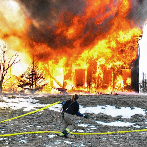 A fire that began in the garage quickly spread to the entirety of a four-bedroom home on Barton Corner Road in Hopkinton on Wednesday. A woman and two dogs were able to evacuate, according to Hopkinton Fire Department, but the home was destroyed.