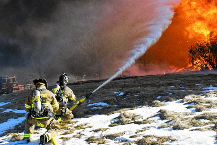 A fire that began in the garage quickly spread to the entirety of a four-bedroom home on Barton Corner Road in Hopkinton on Wednesday. A woman and two dogs were able to evacuate, according to Hopkinton Fire Department, but the home was destroyed.