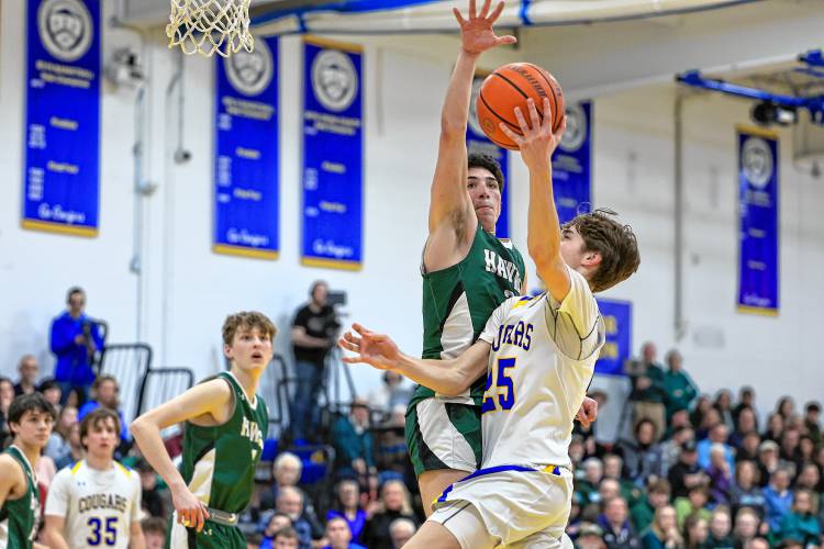 Hopkinton’s Noah Aframe attempts to block a layup from Kearsarge’s Drew Huff during Friday night’s Division III quarterfinal.