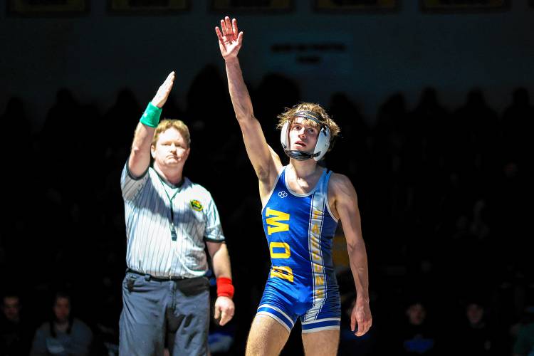 Bow’s Adler Moura raises his hand in celebration after defeating Plymouth’s Anthony Torres in the 113-pound finals at the Division III wrestling championship at Bow High School on Saturday. Moura won his third D-III title and was named the tournament’s Outstanding Wrestler.