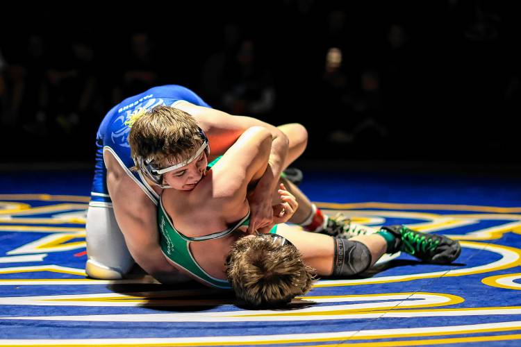 Bow’s Jackson Hall attempts to pin Monadnock’s Seth Adams in the 215-pound final at the Division III wrestling championship at Bow High School on Saturday. Hall won the match in a 7-5 decision to claim the 215 crown.