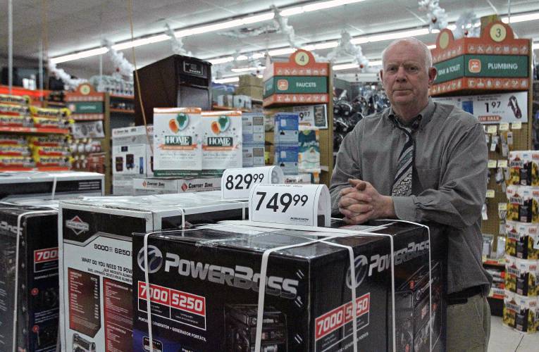 Jeff Ginn, manager of Aubuchon Hardware on South Main Street in Concord, leans on a stack of portable generators in the store on Saturday, Nov. 29, 2014. Ginn had picked up the inventory of generators from the company's Lee location on Friday but had not sold any once they were in stock.