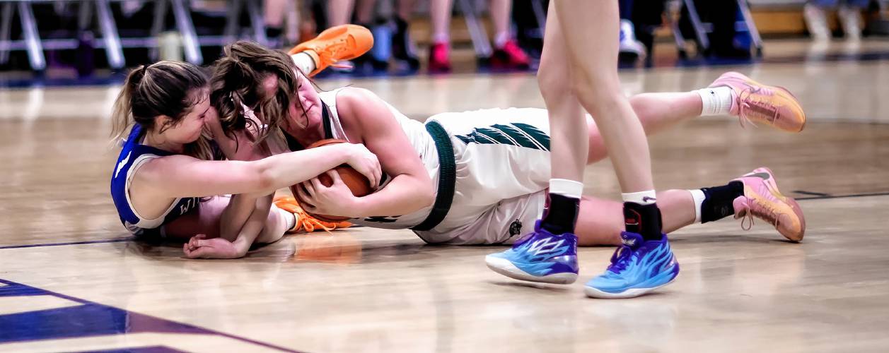 Hopkinton’s Sydney Westover (right) battles Winnisquam forward Bella Sargent during the second half at Bow High School during the D-III semi-finals on Wednesday, February 21, 2024.