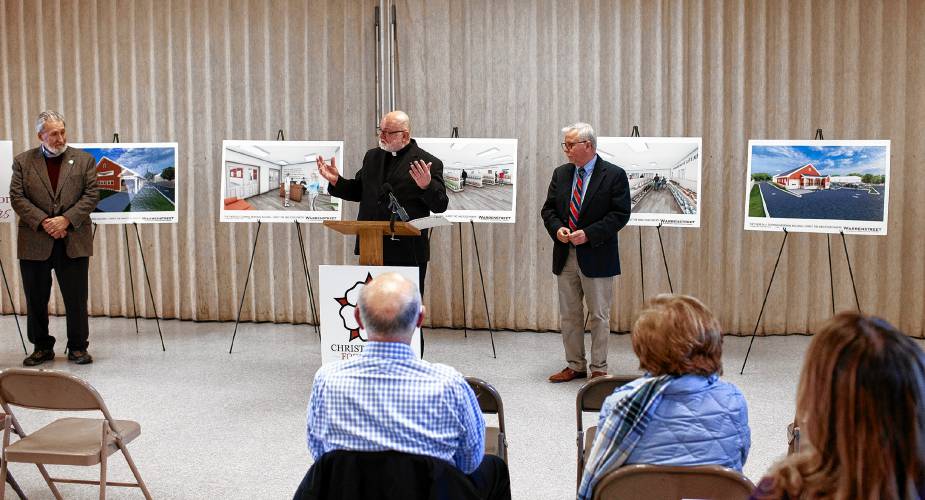 Father Richard Roberge (center), pastor of Christ the King Catholic Church, talks about the new food pantry on the campus as Mayor Byron Champlin (left), and Tim Sink of the Greater Concord Chamber of Commerce look on.