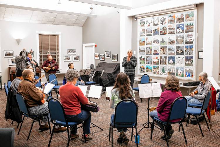 Ric Waldman welcomes the Ukelele group at the Hopkinton community room at the town library on Tuesday, February 20, 2024. The group meets once a month to play and sing.