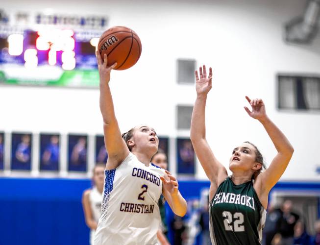 Concord Christian guard Taylor Rioux (2) goes up against Pembroke guard Taylor Renna (22) during the first half of a Jan. 30 game in Concord. The Kingsmen, winners of Division IV and Division III state championships the past two winters, are the top seed in this year’s Division II state tournament.
