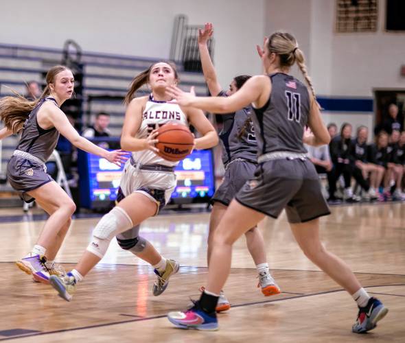 Bow forward Kendall Murray (32) drives to the basket in between Merrimack Valley defenders during the first half on Wednesday.