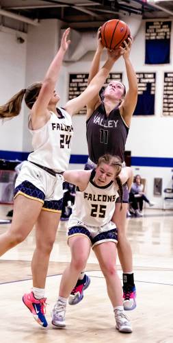 Bow guard Bryana Szepan tries to block out Merrimack Valley forward Kayla Smith as Bow forward Kathryn McGovern trys to corral a rebound during the second half on Wednesday, February 28, 2024.