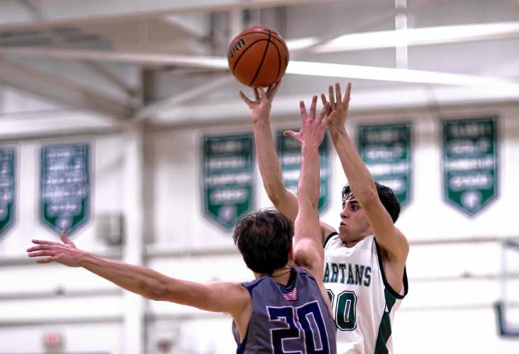 Pembroke guard Joe Fitzgerald takes a 3-pointer over center Logan Gabour in the second half of a Division II quarterfinal game against Merrimack Valley on Friday night.