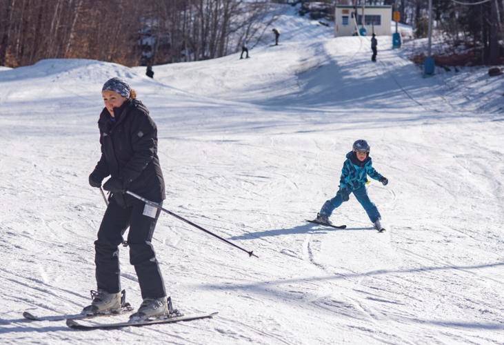 Mary Nolin, left, of Sanbornton, and her son Nolin Hibbard, 5, ski at the Veterans Memorial Ski Area in Franklin on Sunday afternoon. Nolin grew up in Stark, where she spent a lot of time learning to ski at Cannon Mountain, including during ski trips for her school gym class. She now takes her children to learn how to ski at The Vets.