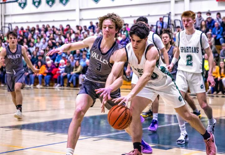 Pembroke guard Joe Fitzgerald (right) battles guard Boston Bradicich during the first half of the Division II quarterfinal against Merrimack Valley on Friday night.