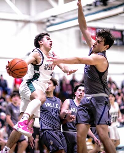 Pembroke guard Evan Berkeley whips a pass around Merrimack Valley center Logan Gabour during the second half of the Division II quarterfinal game on Friday night.