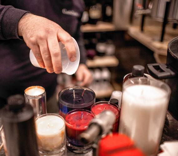 Ross Mingarelli pours the hot soy wax for his speciality candles at is downtown Candle Tree Soy Candle shop.