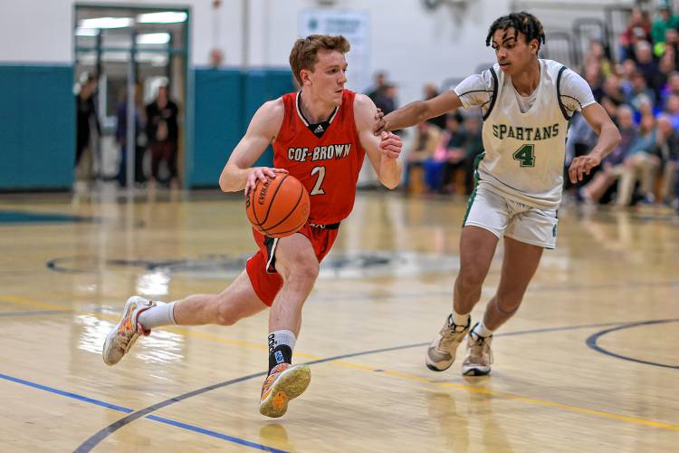 Connor Bagnell drives to the basket for Coe-Brown against Pembroke's Javien Sinclair on Feb. 19, 2024.