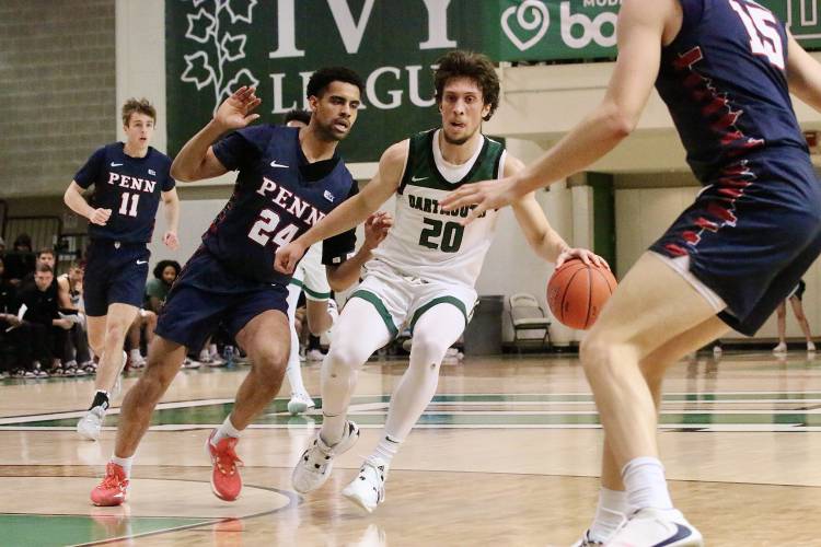 Dartmouth College guard Romeo Myrthil (20) drives against Penn's Reese McMullen (24) during the Ivy League teams' Feb. 23, 2024, meeting at Leede Arena in Hanover, N.H. Penn won, 82-69. (Valley News - Tris Wykes) Copyright Valley News. May not be reprinted or used online without permission. —Tris Wykes valley news photographs — Tris Wykes