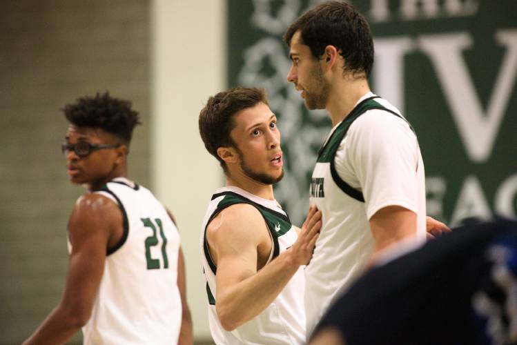 Dartmouth guard Romeo Myrthil, middle, forward Brandon Mitchell-Day, left, and forward Jackson Munro, right, break up from a huddle during a pause in play with Westfield at Leede Arena in Hanover, N.H., on Wednesday, Nov. 16, 2023. Myrthil is one of three players the team chose to speak about their unionization effort. (Valley News - James M. Patterson) Copyright Valley News. May not be reprinted or used online without permission. Send requests to permission@vnews.com.