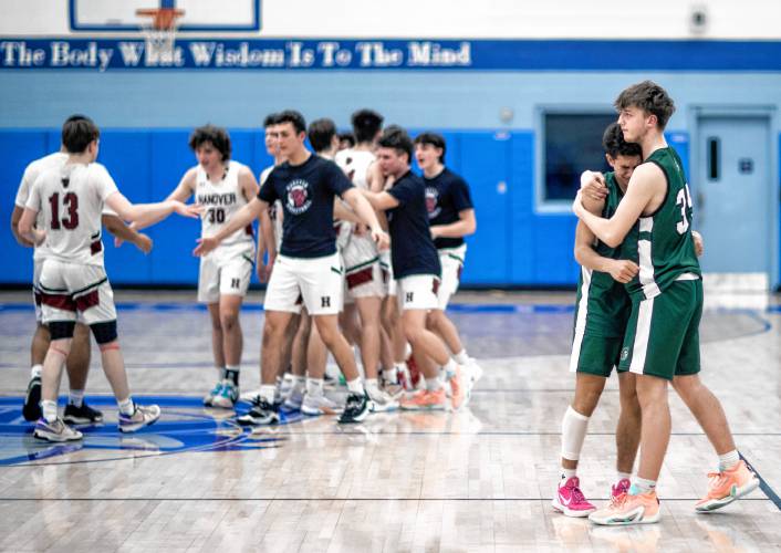 Pembroke forward Aidyn Jeski comforts teammate Evan Berkeley as the Hanover team begins to celebrate during the end of the Division II semifinal at Oyster River High School on Tuesday, March 5, 2024.