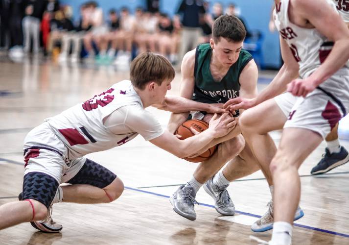 Pembroke guard Zach Bemis battles Hanover guard Ryan Mclaughlin during the second half of the Division II semifinal at Oyster River High School on Tuesday, March 5, 2024.