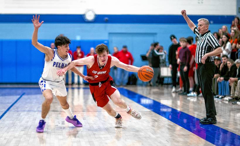 Coe-Brown forward Connor Bagnell gets foulded by Pelham guard Dom Herrling during the first half at Oyster River High School on Tuesday night, March 5, 2024 during the Division II semifinal game.