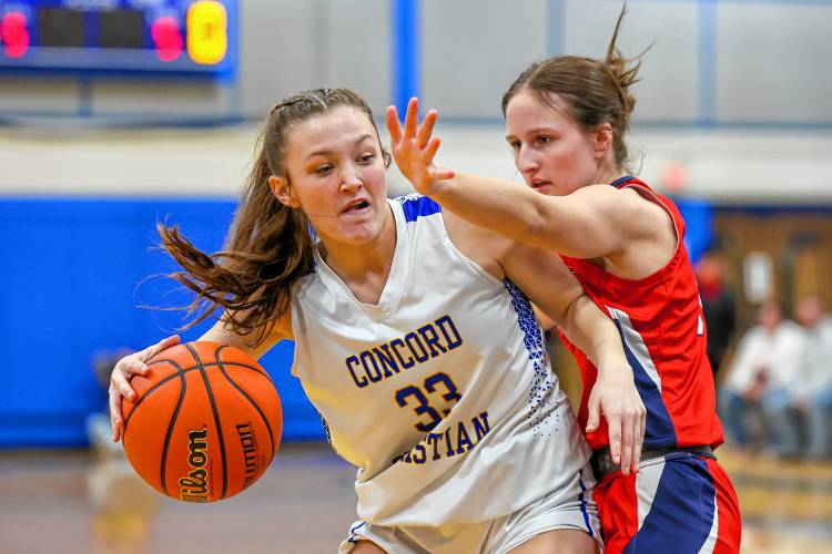 CCA’s Lilli Carlile (33) backs her way down on John Stark’s Hayleigh Dennis in Wednesday’s D-II semifinal win for the Kingsmen.