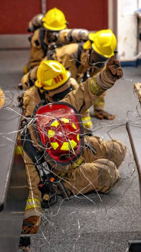 Addison “Nails” Bergeron leads the group through the obstacle course at their CRTC firefighter class at Concord High School on Thursday, March 7, 2024.