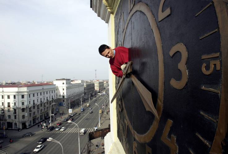 Technician Oleg Ryabtsev performs maintenance work on a clock in Minsk, Belarus, Saturday, March 29, 2008.