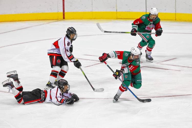 Cam Plumb (11) controls the puck for Pembroke-Campbell during Saturday's Division III boys' hockey championship at SNHU Arena.