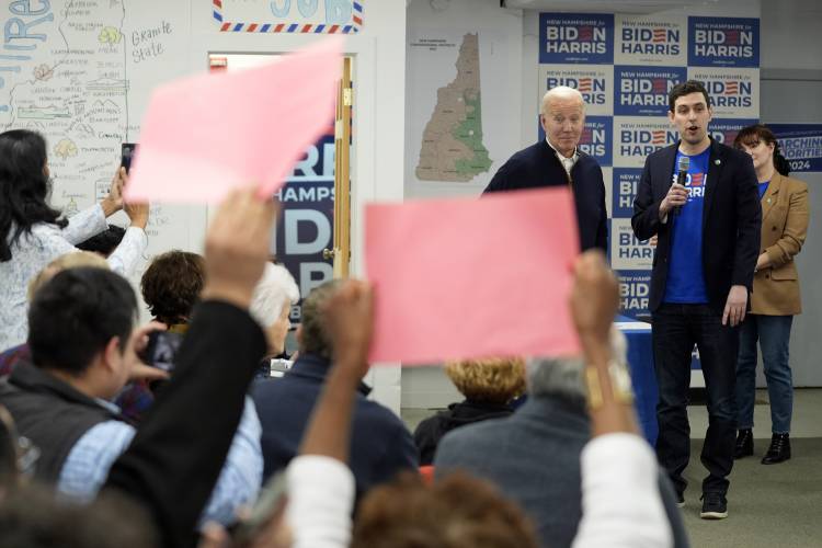 President Joe Biden, third from right, is greeted by supporters during a visit to a campaign field office, Monday, March 11, 2024, in Manchester, N.H. (AP Photo/Evan Vucci)