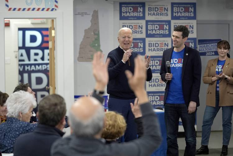 President Joe Biden, third from right, is greeted by supporters during a visit to a campaign field office, Monday, March 11, 2024, in Manchester, N.H. (AP Photo/Evan Vucci)