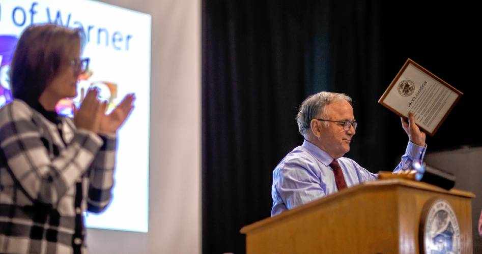 Outgoing Warner town moderator Ray Martin acknowledges the crowd after receiving a proclamation for his service.