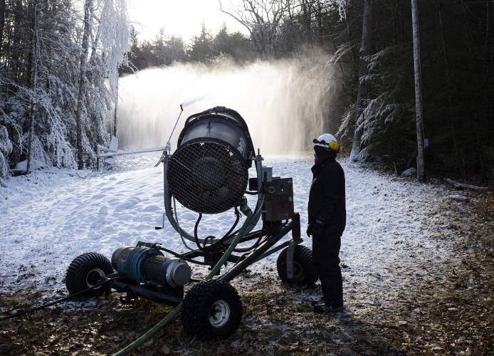 Pats Peak groomer George Dean helps out turning off the snow making  fan gun on top of the mountain.
