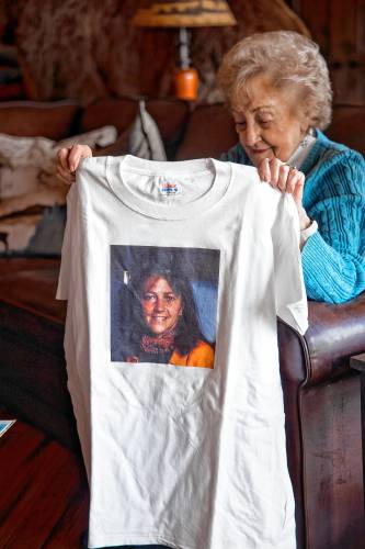 Maddie Dionne holds up a tee shirt of her daughter, Bobbie, at her son’s home in New Boston.