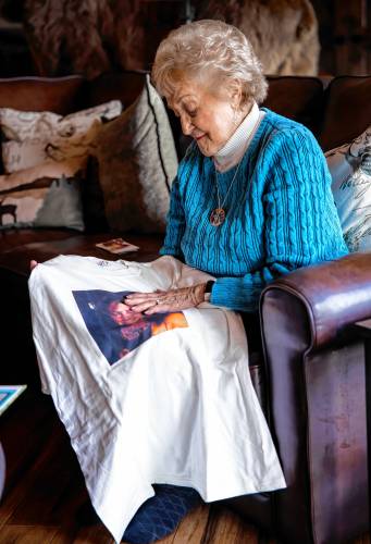 Maddie Dionne touches her daughter, Bobbieâs face on a tee shirt she made at her sonâs home in New Boston.