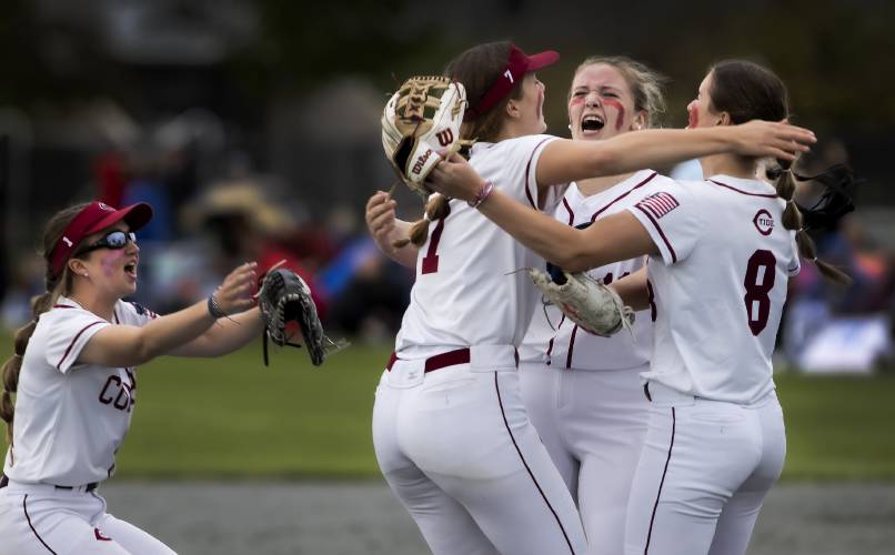 Concord pitcher Maddy Wachter (second from right) is surrounded by teammates Sarah Taylor (8) and Brooke Wyatt (7) as Lillian Hacket rushes in after the Tide got the last out to win the Division I softball championship last June at Plymouth State University. The Crimson Tide has plenty of that championship talent coming back this spring, but they’ll also have to work with a small varsity roster.