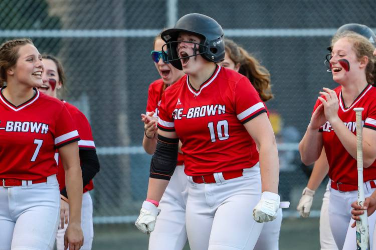 Coe-Brown’s Courtney Thomas (10) celebrates with her teammates at home plate after hitting a three-run home run in last year’s D-II title game win over Kingswood.
