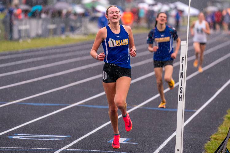 Kearsarge’s Molly Ellison (center) crosses the finish line to claim the 1,600-meter title at the NHIAA Division III track and field championship last May at Sanborn Regional High School. Ellison won the 1,600 in 5:30 and the 3,200 in 11:50 to lead Kearsarge to second place as a team in D-III.