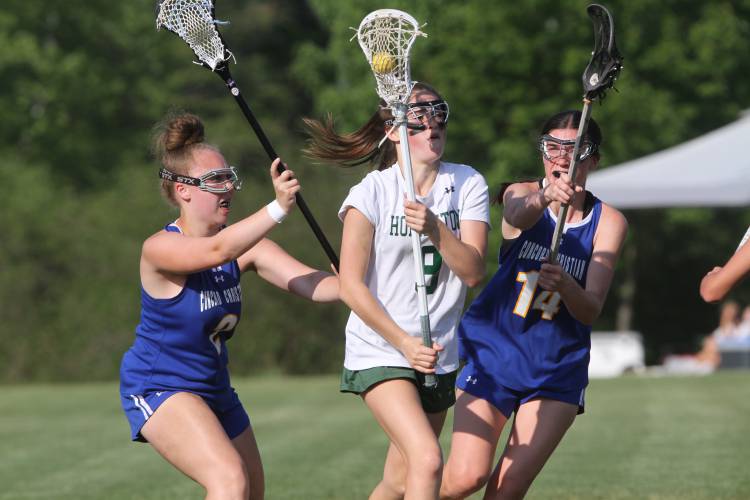 Hopkinton’s Maeve Owens (9) attempts to carry the ball up field in the first half while Concord Christian’s Taylor Rioux (2) and Lauren Winans (14) defend in a D-III tournament game last June.
