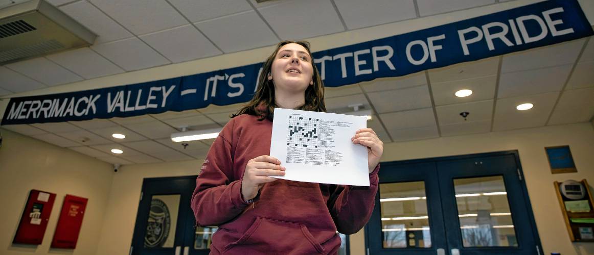 Merrimack Valley High School senior Natalie DeGreenia holds up one of her crossword puzzles she has created for her senior project on Wednesday, April 3, 2024 in the foyer of the school.