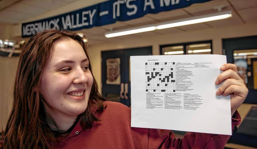 Merrimack Valley High School senior Natalie DeGreenia holds up one of her crossword puzzles she has created for her senior project on Wednesday, April 3, 2024 in the foyer of the school.