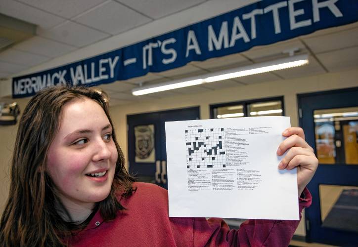 Merrimack Valley High School senior Natalie DeGreenia holds up one of her crossword puzzles she has created for her senior project on Wednesday, April 3, 2024 in the foyer of the school.